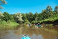 Family kayak trip. Man and woman and elderly couple senior and seniora rowing boat on the river, a water hike, a summer adventure Royalty Free Stock Photo