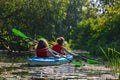 Family kayaking, mother and child paddling in kayak on river canoe tour, active autumn weekend and vacation, sport and fitness Royalty Free Stock Photo