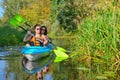 Family kayaking, mother and child paddling in kayak on river canoe tour, active autumn weekend and vacation, sport and fitness Royalty Free Stock Photo