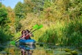 Family kayaking, mother and child paddling in kayak on river canoe tour, active autumn weekend and vacation, sport and fitness Royalty Free Stock Photo