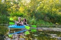 Family kayaking, mother and child paddling in kayak on river canoe tour, active summer weekend and vacation