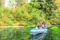 Family kayaking, mother and child paddling in kayak on river canoe tour having fun, active weekend and vacation, fitness co