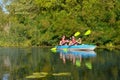 Family kayaking, mother and daughter paddling in kayak on river canoe tour having fun, active autumn weekend with children