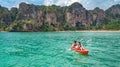 Family kayaking, mother and daughter paddling in kayak on tropical sea canoe tour near islands, having fun, vacation in Thailand Royalty Free Stock Photo