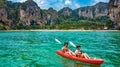 Family kayaking, mother and daughter paddling in kayak on tropical sea canoe tour near islands, having fun, vacation in Thailand