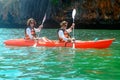 Family kayaking, mother and daughter paddling in kayak on tropical sea canoe tour near islands, having fun, active vacation Royalty Free Stock Photo