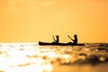 Family kayaking at sunset