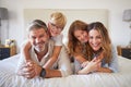 Family, kids and bedroom with a girl, boy and parents lying on a bed in their home together in the morning. Children Royalty Free Stock Photo