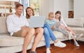 Family, kids and with digital devices have smile, together and happy in living room on couch. Children, parents and love Royalty Free Stock Photo