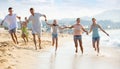 Family with kids happily running together on beach Royalty Free Stock Photo