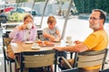 Family with kids having breakfast in outdoor cafe or restaurant Royalty Free Stock Photo