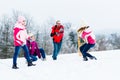 Family with kids having snowball fight in winter Royalty Free Stock Photo