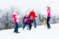 Family with kids having snowball fight in winter Royalty Free Stock Photo