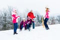 Family with kids having snowball fight in winter Royalty Free Stock Photo