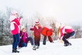 Family with kids having snowball fight in winter Royalty Free Stock Photo