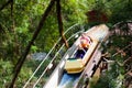 Family with kids on roller coaster in amusement theme park. Children riding high speed water slide attraction in entertainment fun Royalty Free Stock Photo