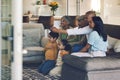 Family, kids and watching tv on sofa with grandparents, parents or remote control for choice in home. Men, women and Royalty Free Stock Photo