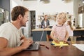 Family kitchen, dad and son working at the table, close up