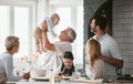 .Family, kitchen and grandpa playing with baby having fun, bonding and relax together. Big family, support or care of