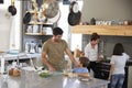 Family In Kitchen Making Morning Breakfast Together