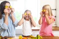 Family in the kitchen preparing a fresh fruit salad at the kitchen Royalty Free Stock Photo