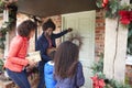 Family Knocking On Front Door As They Arrive For Visit On Christmas Day With Gifts Royalty Free Stock Photo