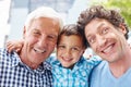 This family knows how to have fun. Portrait of a little boy with his father and grandfather.