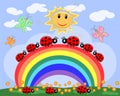 A family of ladybirds creeps along a seven-color rainbow under the sun on a spring, summer day Royalty Free Stock Photo