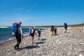 Family with large backpacks are on road sea