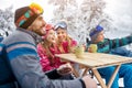 Family laughing and takes tea break during skiing on the mountain Royalty Free Stock Photo