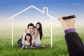 Family laughing under a dream home Royalty Free Stock Photo