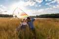 Family launches kite against beautiful sky