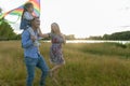 Family launches kite against beautiful sky