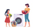 Family in laundry. Mother and daughter loading dresses in washing machine, heap apparel with stains, dirty clothes