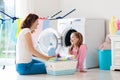 Family in laundry room with washing machine Royalty Free Stock Photo