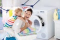 Family in laundry room with washing machine Royalty Free Stock Photo