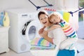 Family in laundry room with washing machine Royalty Free Stock Photo