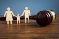 Family law and adoption concept. Figures and gavel. Royalty Free Stock Photo