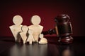 Family law civilian concept - wooden people family figures and wooden gavel on table Royalty Free Stock Photo