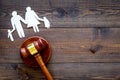 Family law, family right concept. Child-custody concept. Family with children cutout near court gavel on dark wooden