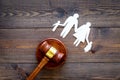 Family law, family right concept. Child-custody concept. Family with children cutout near court gavel on dark wooden