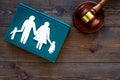 Family law, family right concept. Child-custody concept. Family with children cutout near court gavel on dark wooden Royalty Free Stock Photo