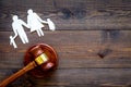 Family law, family right concept. Child-custody concept. Family with children cutout near court gavel on dark wooden