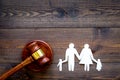 Family law, family right concept. Child-custody concept. Family with children cutout near court gavel on dark wooden Royalty Free Stock Photo