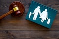 Family law, family right concept. Child-custody concept. Family with children cutout near court gavel on dark wooden Royalty Free Stock Photo