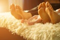 Family laying on bed, their feets on focus. Mother, father and newborn baby son Royalty Free Stock Photo