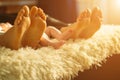 Family laying on bed, their feets on focus. Mother, father and newborn baby son Royalty Free Stock Photo