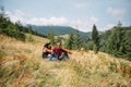 Family laying down the grass enjoying mountain view Royalty Free Stock Photo