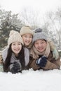 Family laying in snow for portrait