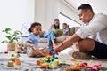 Family, learning and building toy by girl and father bond living room floor, playing, relax and creative puzzle fun